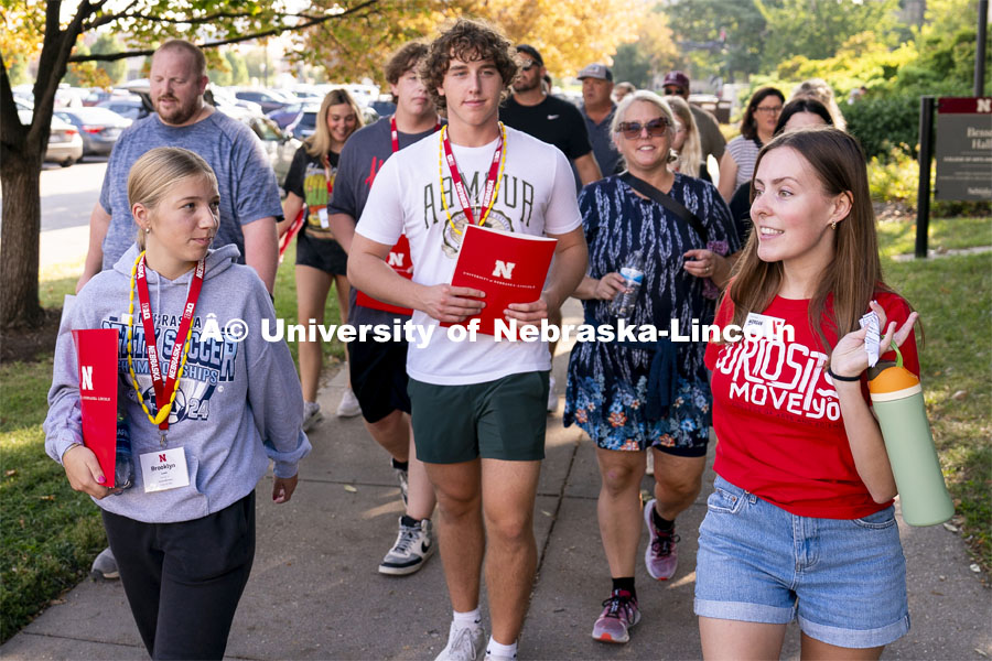 Campus host Morgan Tracy (right) leads a group of high school students and parents in a tour around campus during Red Letter Day. September 13, 2024. Photo by Jordan Opp for University Communication.